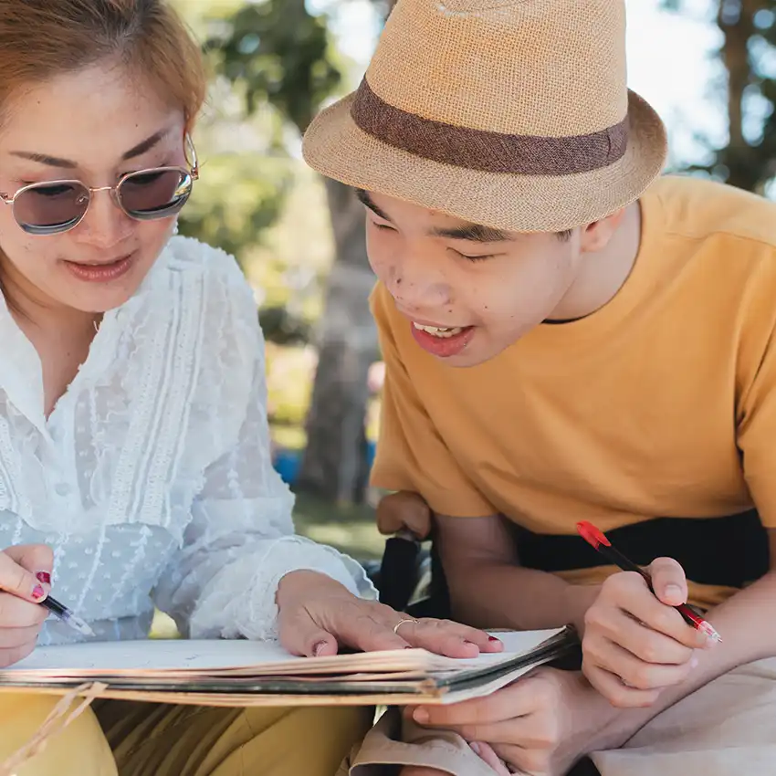 Adult and support worker reviewing a daily plan together at home.