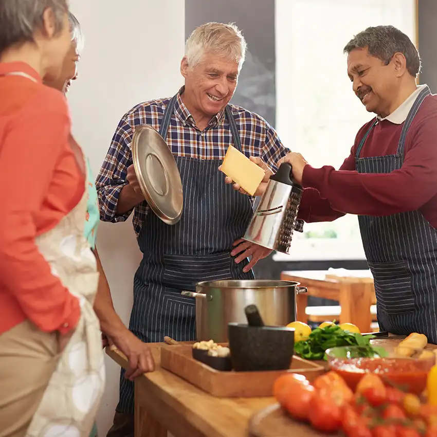 Two adults preparing a meal together in a home kitchen.
